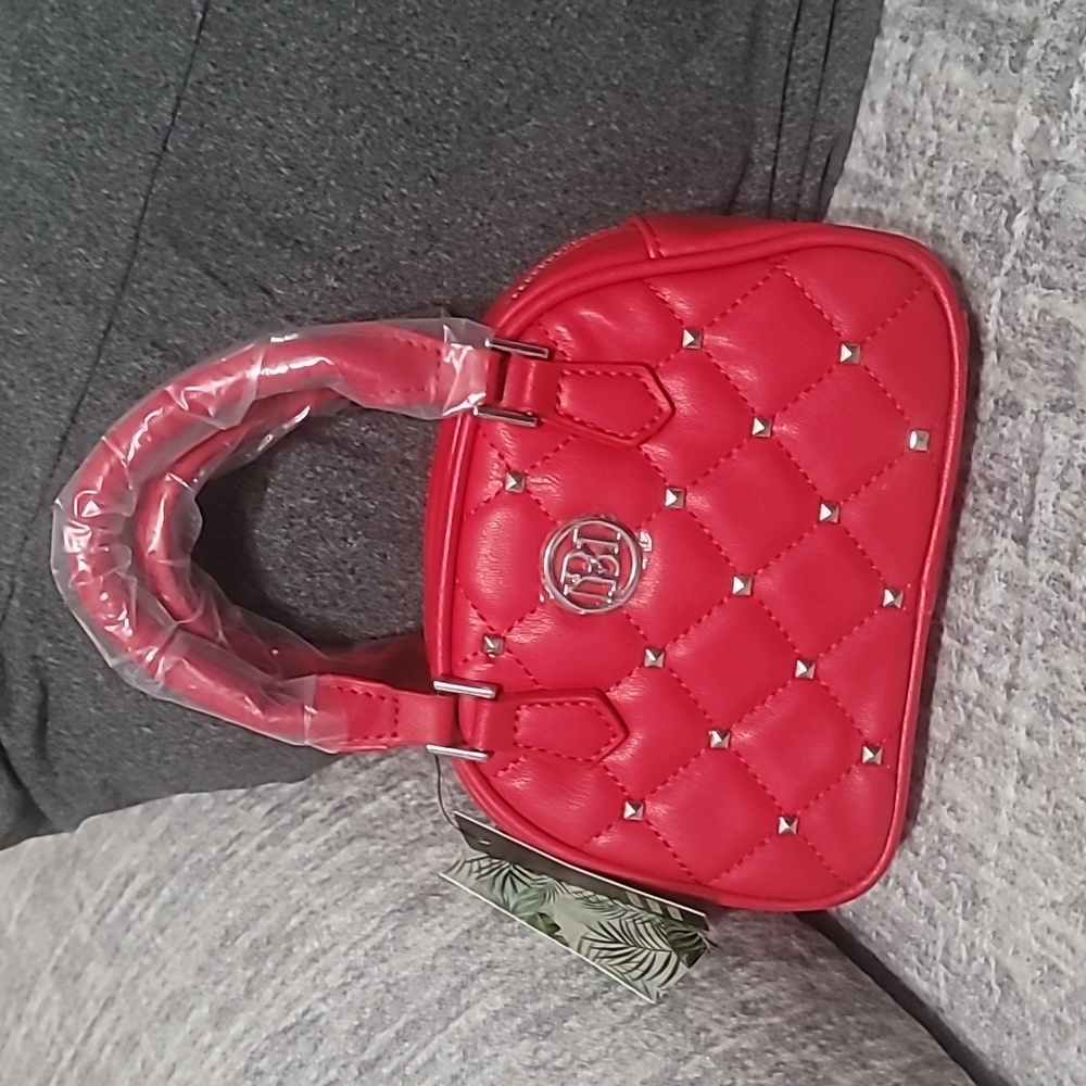 Badgley Mischka red mini bag with silver hardware which is still protected.